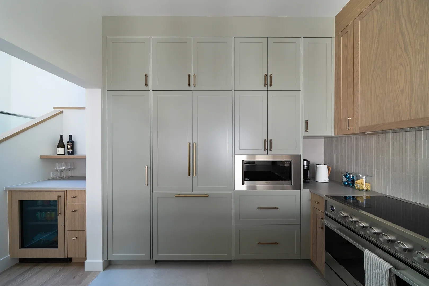 Kitchen with floor to ceiling painted cabinets with an inset microwave