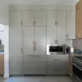 Kitchen with floor to ceiling painted cabinets with an inset microwave
